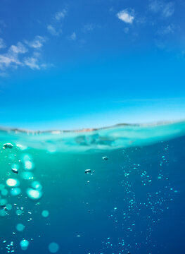 Underwater split images of pool water surface and sky