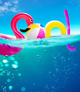 Pool Text Made Of Inflatable Water Toys Underwater Split Photo