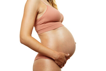 Close-up in profile of a pregnant woman's belly