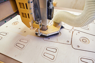 Wooden CNC machine in work. Device with numerical control. Woodworking industry