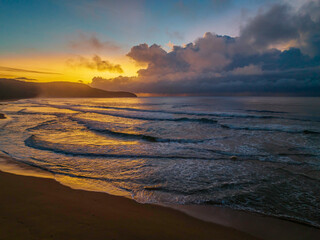 Sunrise seascape with rain clouds on the horizon