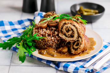 Beef rolls with mushrooms and sauce. rustic style