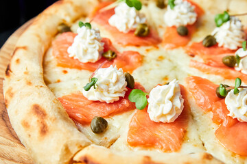 Pizza with salmon and cream cheese. Close-up, selective focus