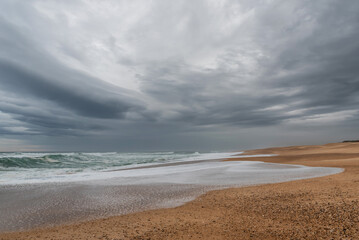Fototapeta na wymiar Waves and threatening clouds at Ondres Beach. Landes 
