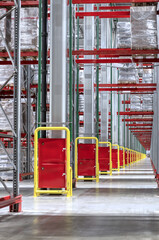 Lifting equipment with cargo near high shelving in storage