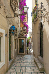 Fototapeta premium Taormina (Sicilia, Italy) - A historical center view of the touristic city in province of Messina, Sicily island, during the summer, famous for Isola Bella beach and the old theatre