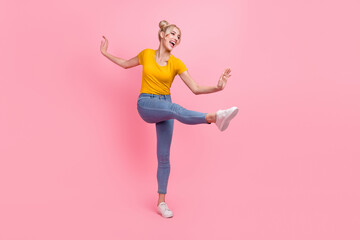 Full body photo of cool young blond lady dance wear t-shirt jeans sneakers isolated on pink color background