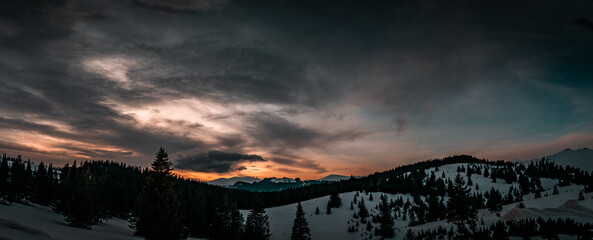 sunset in the mountains at sunset with dark clouds