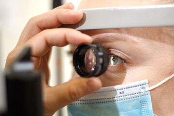 Close-up portrait of a female patient checking eyesight in an ophthalmologist clinic