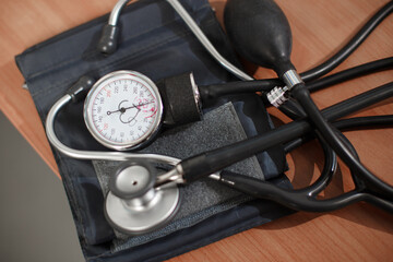 Tonometer with mechanical device for measuring pressure and a doctors hands writing recepy in the background