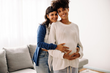 Cheerful pregnant couple smiling at the camera