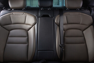 Luxury car rear seats row. Expensive car leather seats, view from the front seats.