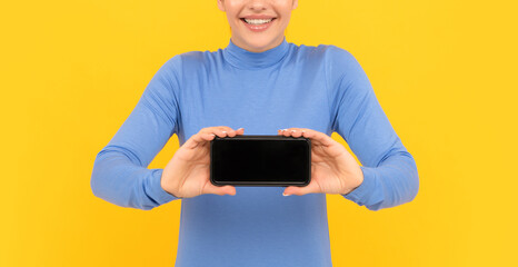 glad woman hold mobile phone with screen for copy space, advertisement