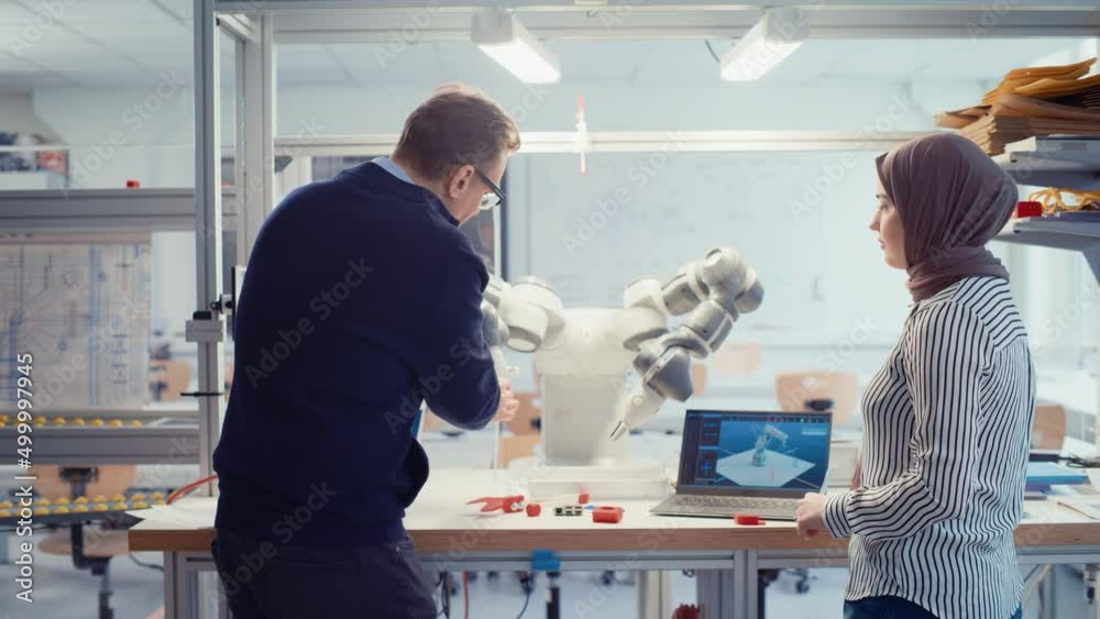Aufkleber Arabic Female Promising Computer Scientist Asking Her Professor While Discussing Robotic Arm Working to While Gathering at the Table. Innovative Firm Startup Concept. Slow Motion