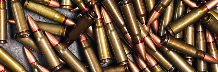 Bullets background texture banner. Cartridges 7.62 caliber for Kalashnikov assault rifle. Panoramic web header. Wide screen wallpaper