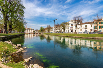 Cityscape of Treviso downtown with the river Sile with the street called Riviera Garibaldi and the small bridge called Ponte Dante. Veneto, Italy, Europe.
