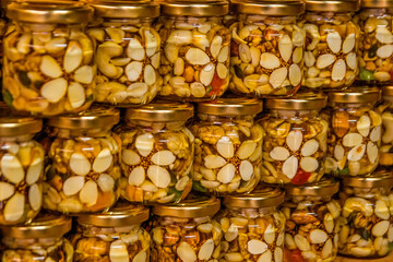 Honey and nuts in jars on display. Lots of jars with nuts and honey