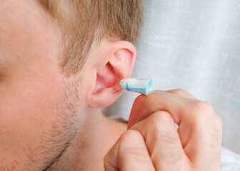 Silicone earplug next to the ear. Insert ear protection