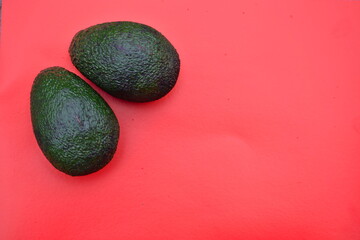 Avocados in the red background 