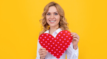 positive woman with red love heart on yellow background