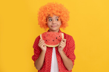 fancy teen girl having fun. summertime. face of child with orange hair hold water melon slice