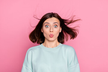 Photo of young woman pouted lips send air kiss unbelievable news isolated over pink color background
