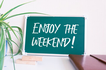 Enjoy the weekend word on chalkboard, message