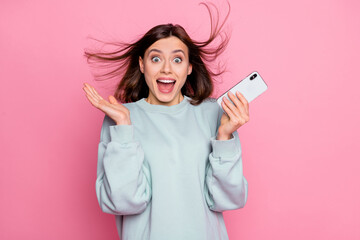Naklejka premium Photo of hooray bob hairstyle millennial lady hold telephone wear hoodie isolated on pink background