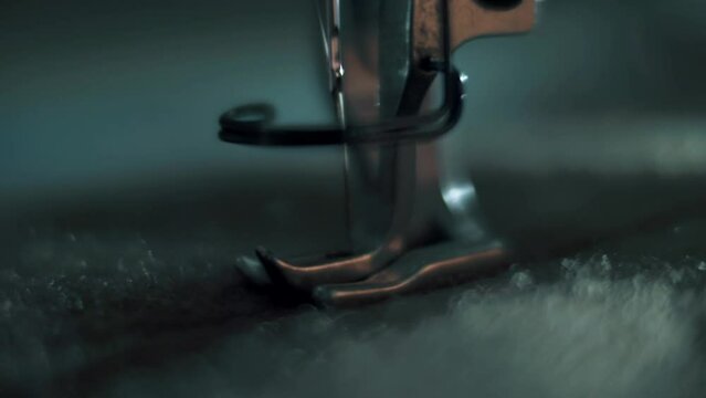 The needle and foot of the sewing machine penetrat