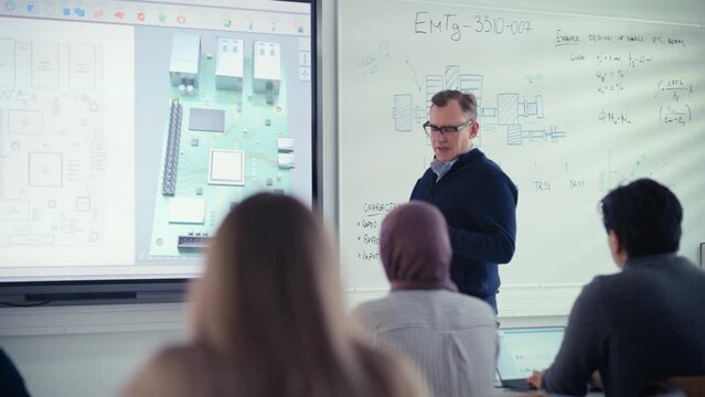 Male Educator Use projection screen  and Explain to Diverse Students About Computer Motherboard Components while Point at it. Education, Computer Science and High Tech Concept. Slow Motion