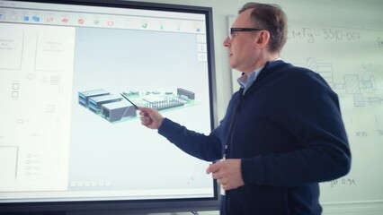 Male Teacher Use Digital Screen, Talk to People and Show 3D Computer Motherboard Components at College. Innovative Techniques in Instruction Technology Concept. Close Up