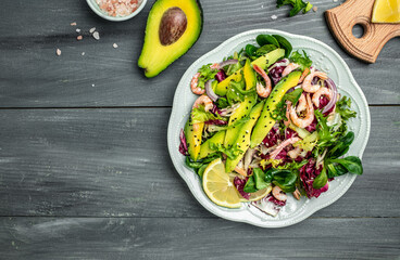 Seafood salad with shrimps, avocado slices and fresh greens, Healthy food. superfood concept. clean eating concept. Vegan or gluten free diet. top view