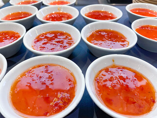 Bowls of sweet chilli dipping sauce.