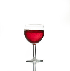 red wine in a transparent glass with reflection isolated over white background