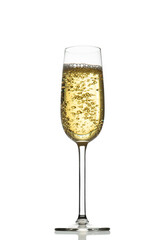 white wine or another golden yellow drink with bubbles in a transparent glass with reflection isolated over white background
