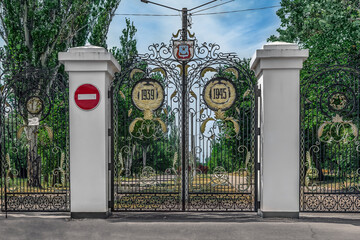 Mykolaiv, Ukraine - July 26, 2020: Decorative forged gate with coats of arms at the entrance to the...