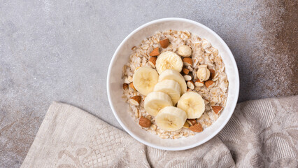 Healthy breakfast with oatmeal, nuts and banana