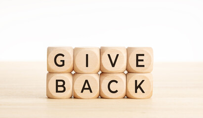 Give back message on wooden blocks. Copy space