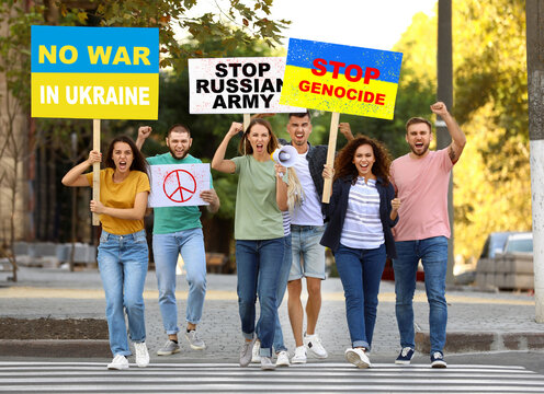 Stop war in Ukraine. Protesting people with placards outdoors - Powered by Adobe