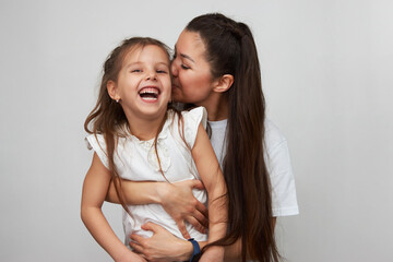 Happy woman and child girl 5-6 years old having fun