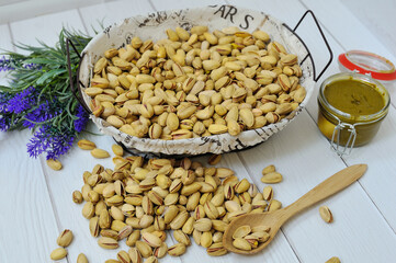 Mixed nuts in a wooden bowl on old table, selective focus.