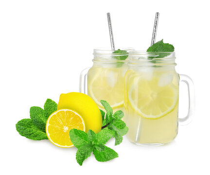 Mason jars with tasty lemonade, fresh ripe fruits and mint on white background