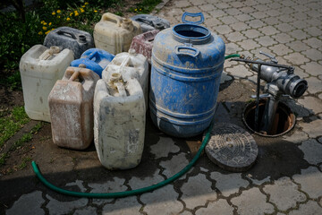 Water hydrant and some big plastic barrels