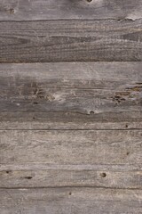 Texture of an old wooden wall. Wooden background. Wall of old cracked boards. Old unfinished boards.