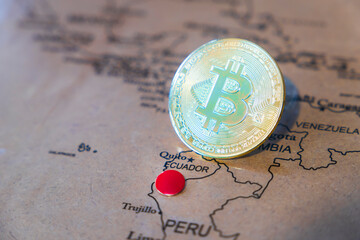 Bitcoin symbol  standing on the world map, Ecuador is pinned on the map