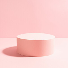 Romantic pastel pink stage with one round podium in bright sunlight with shadow on gentle shine soft light background, square.  Mockup for presentation cosmetic product, goods, advertising, show.
