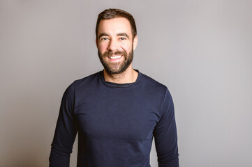 portrait of casual young man with beard white background