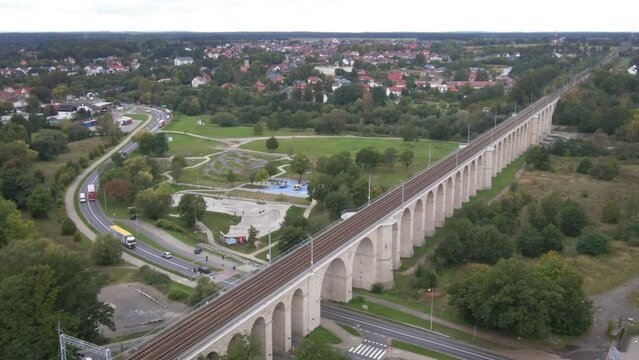 Aerial drone view of the historical railway viaduct over the Bobr River and skatepark in Bolesławiec, Lower Silesia, Poland