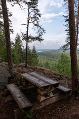 Picnic table and benches at scenic viewpoint in Finland.
