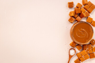 Bowl of caramel sauce and toffee candies with sea salt, top view